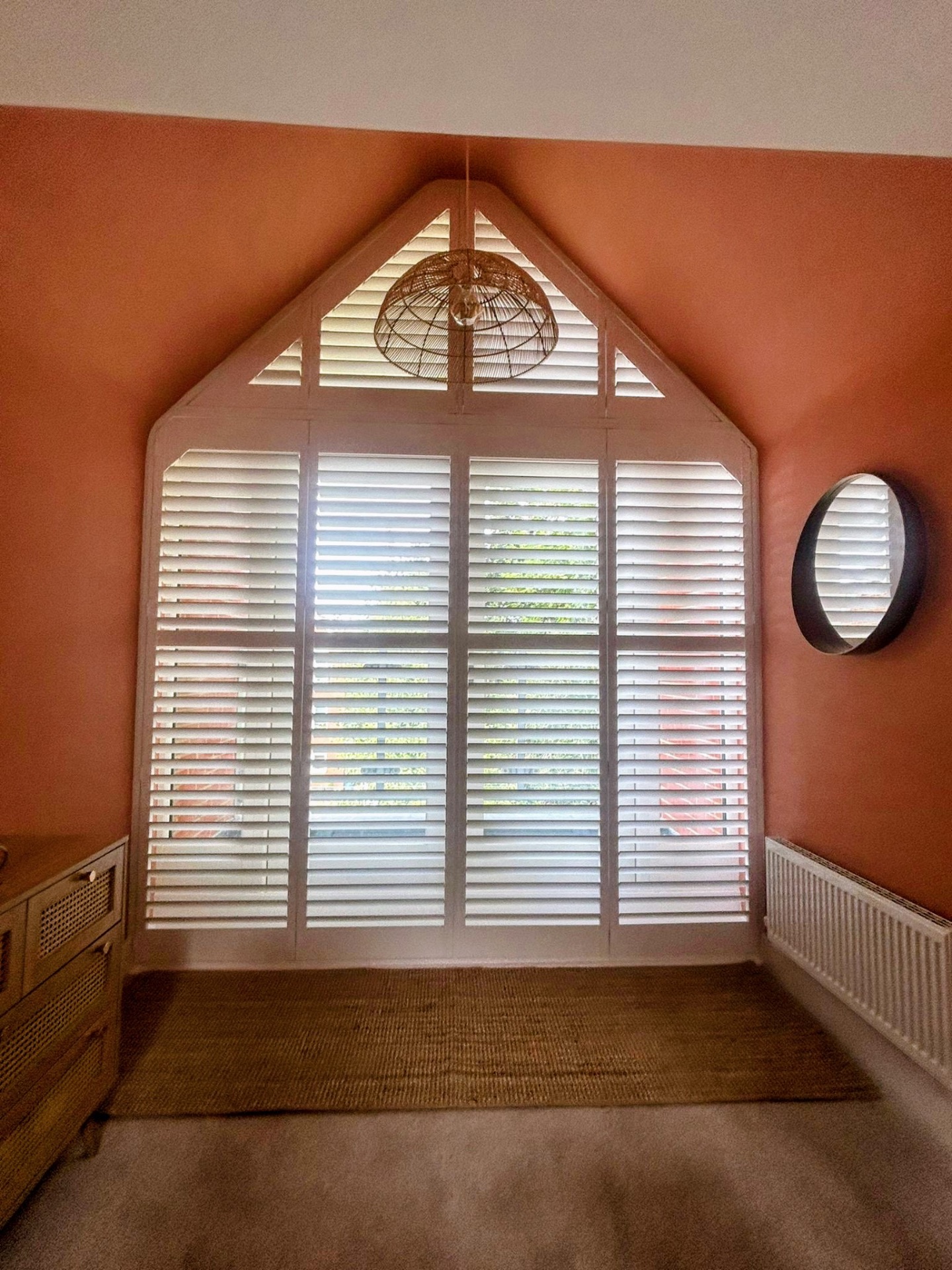 Shaped apex window with bespoke white shutters