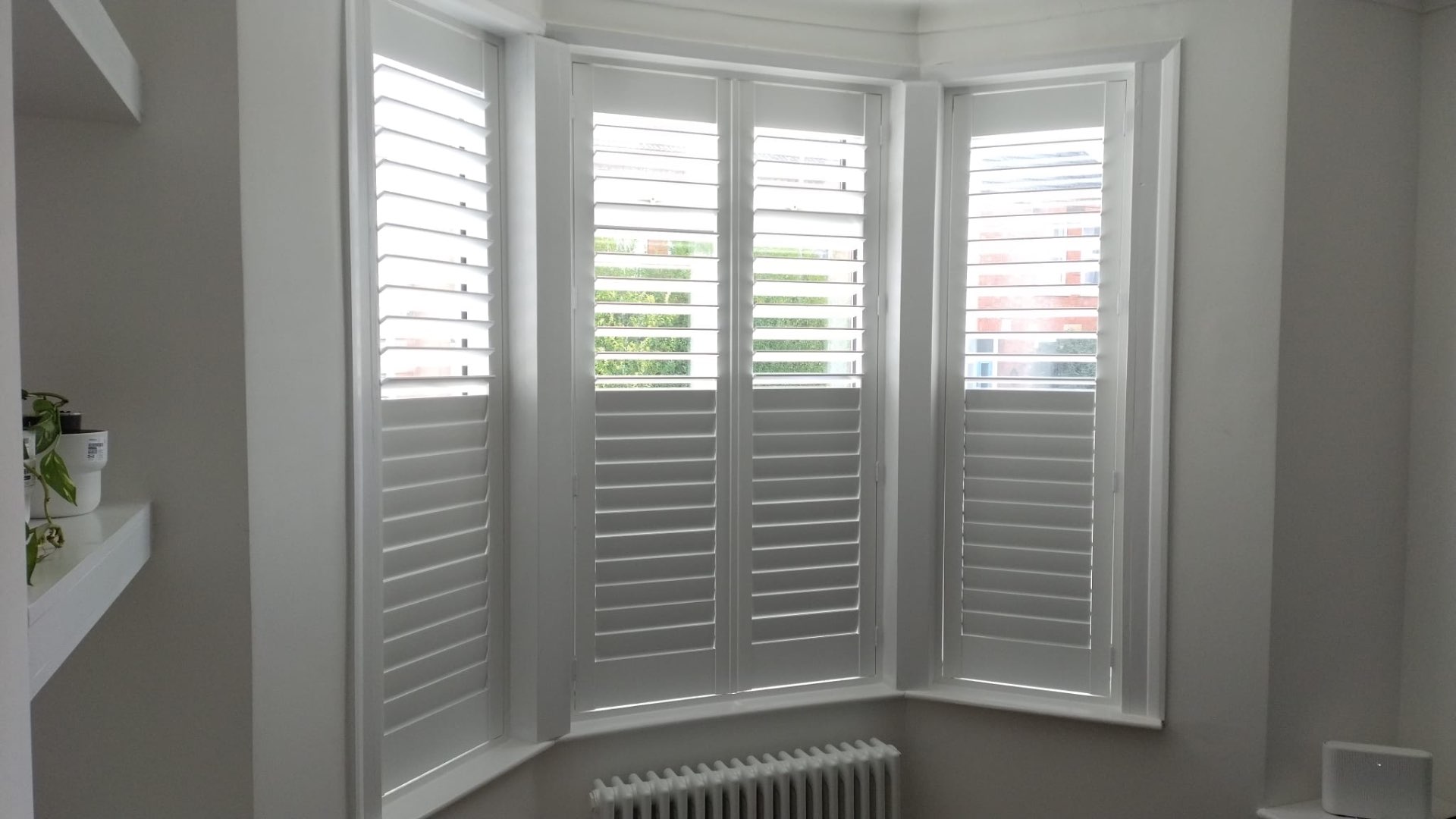 Crisp white bay window shutters