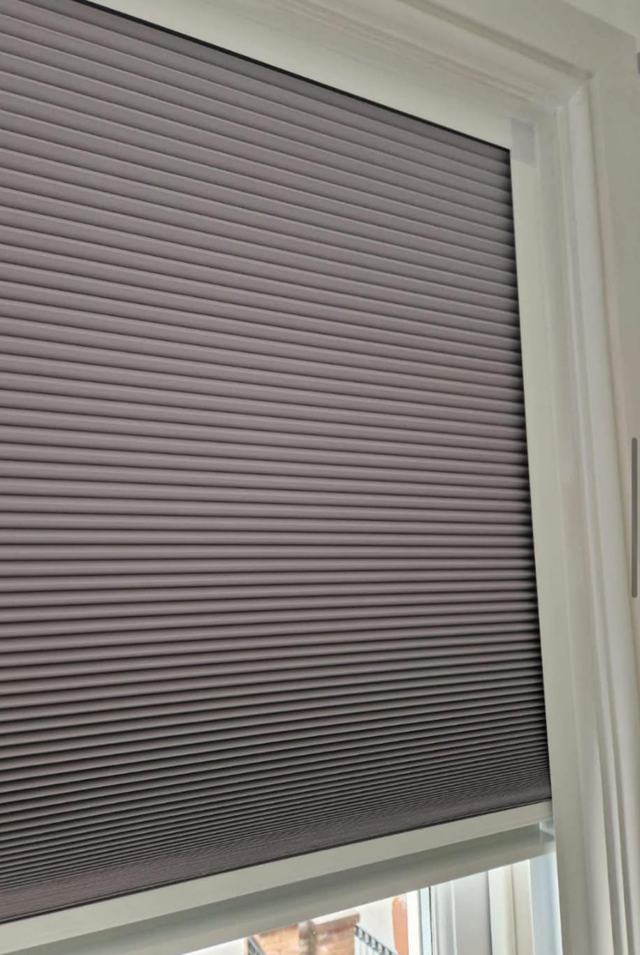 Grey blackout nightshade honeycomb blind fitted to a window